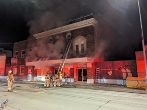 Firefighters battle a blaze at the Lido Theatre in the town of The Pas, Man. in a handout photo. A historic former theatre in northern Manitoba has been hit by fire. RCMP say the blaze broke out early Monday morning.