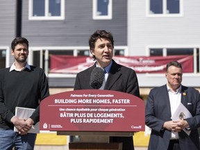 Prime Minister Justin Trudeau, centre, is flanked by Minister of Housing, Infrastructure and Communities Sean Fraser, left, and mayor of Halifax Mike Savage while making a housing announcement in Dartmouth, N.S. on Tuesday, April 2, 2024. Prime Minister Justin Trudeau is set to make a housing announcement in Winnipeg today.
