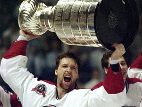 Montreal Canadiens Patrick Roy raises the Stanley Cup