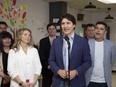 Prime Minister Justin Trudeau speaks as Minister of Families, Children and Social Development, Jenna Sudds, left, and MP Serge Cormier look on during an announcement at Marguerite-Bourgeoys School in Caraquet, N.B., Thursday, May 16, 2024.