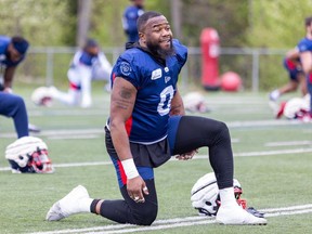 Defensive-lineman Shawn Lemon stretches during Alouettes training camp in St-Jérôme.