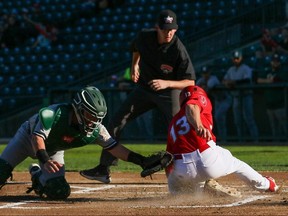 Winnipeg Goldeyes right fielder Max Murphy slides past the tag at home