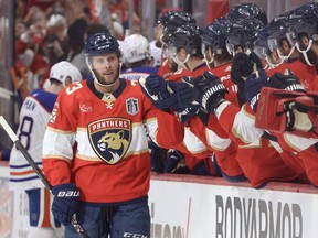 SUNRISE, FLORIDA - JUNE 08: Carter Verhaeghe #23 of the Florida Panthers high fives teammates after scoring a goal during the first period against the Edmonton Oilers in Game One of the 2024 Stanley Cup Final at Amerant Bank Arena on June 08, 2024 in Sunrise, Florida.