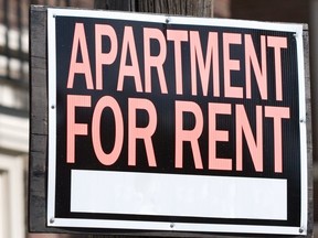 Close-up of a rental sign in front an apartment building.