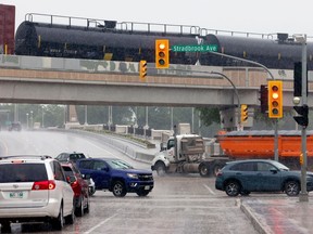 Train crosses the overpass at Main Street.