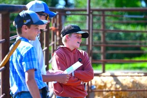 Brayden Steppler with friends Nathan Armstrong and Hayden Collins, taking in the Manitoba Simmental Pen Show this summer.