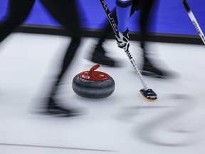 A curling stone slides down the ice sheet at the Scotties Tournament of Hearts in Calgary on Feb. 21, 2024.